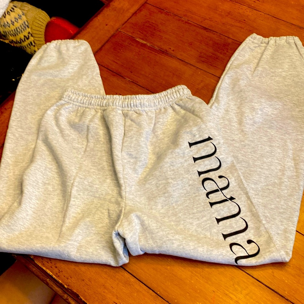 Light grey sweatpants written “mama” on the side